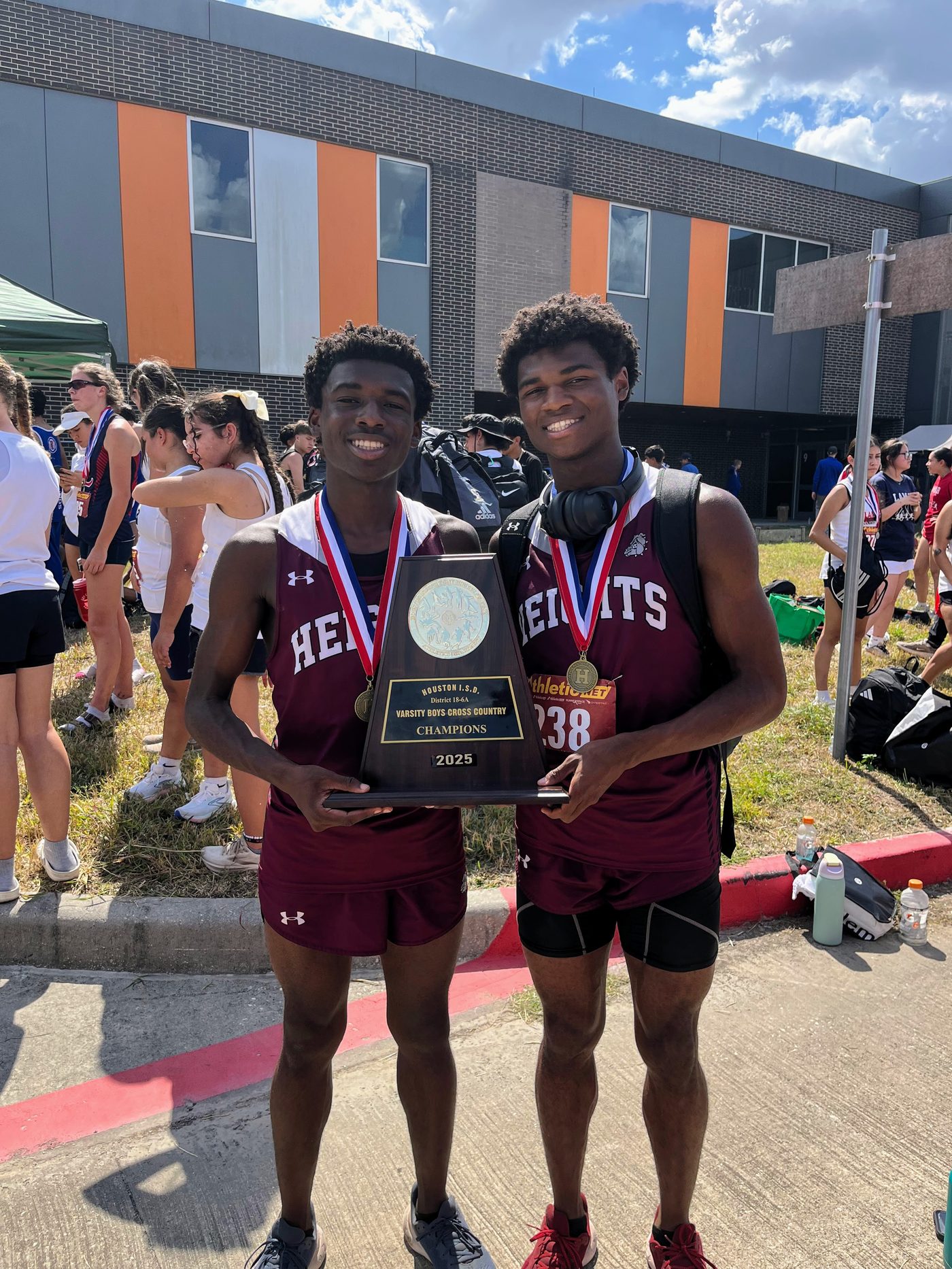 Christian C. Ferguson and a teammate holding the district championship trophy