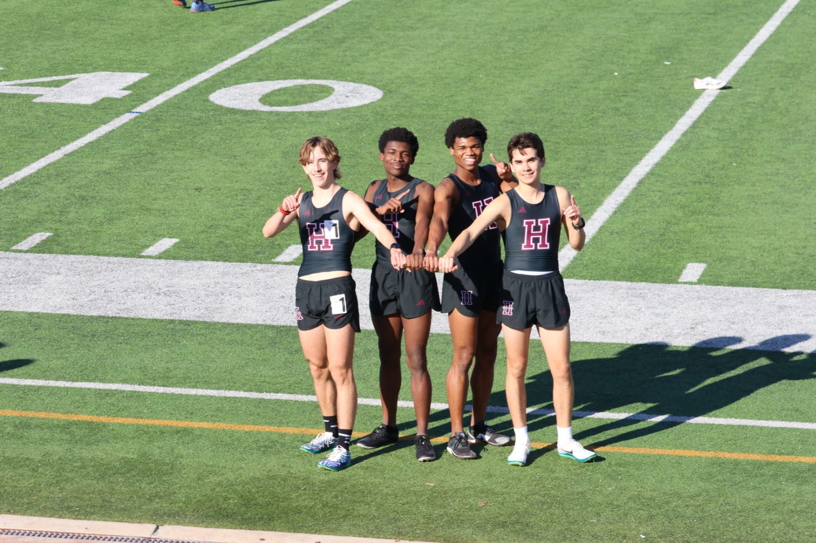 Christian C. Ferguson with the Houston Heights 4x800m relay squad on the field