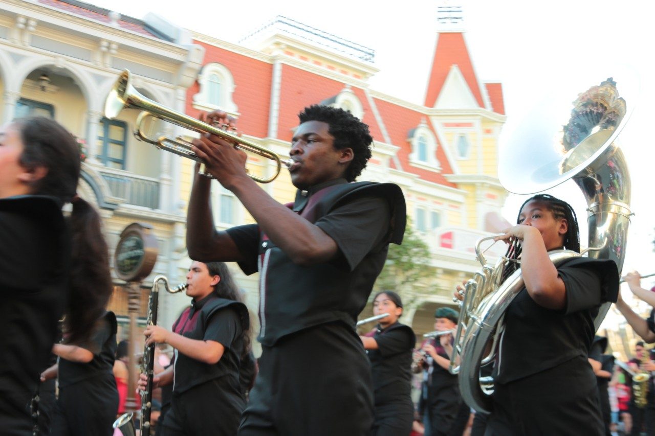 Christian C. Ferguson playing trumpet on parade with the Houston Heights band